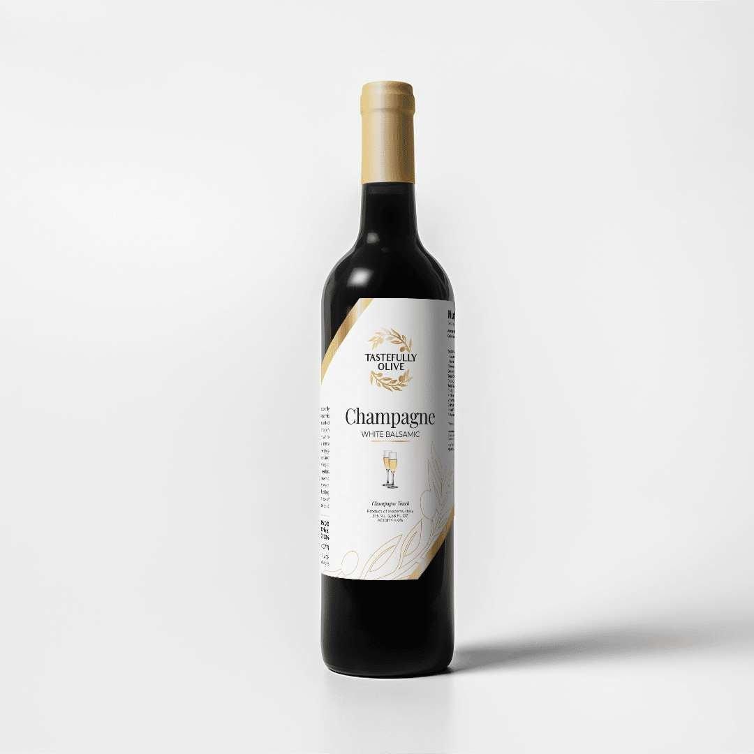 Tastefully Olive Champagne white balsamic bottle with a white label and gold cap on a white background.