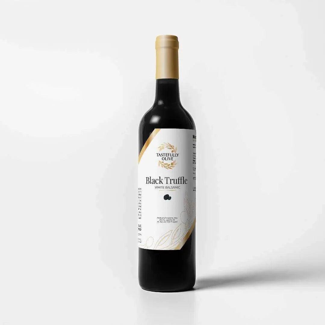 Tastefully Olive Black Truffle white balsamic vinegar bottle with a white label and gold cap on a white background.