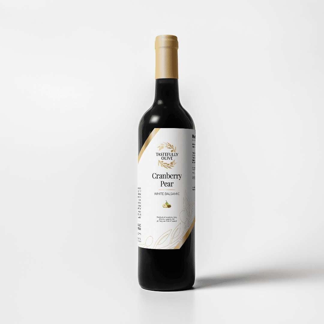 Tastefully Olive Cranberry Pear white balsamic vinegar bottle with a white label and gold cap on a white background.