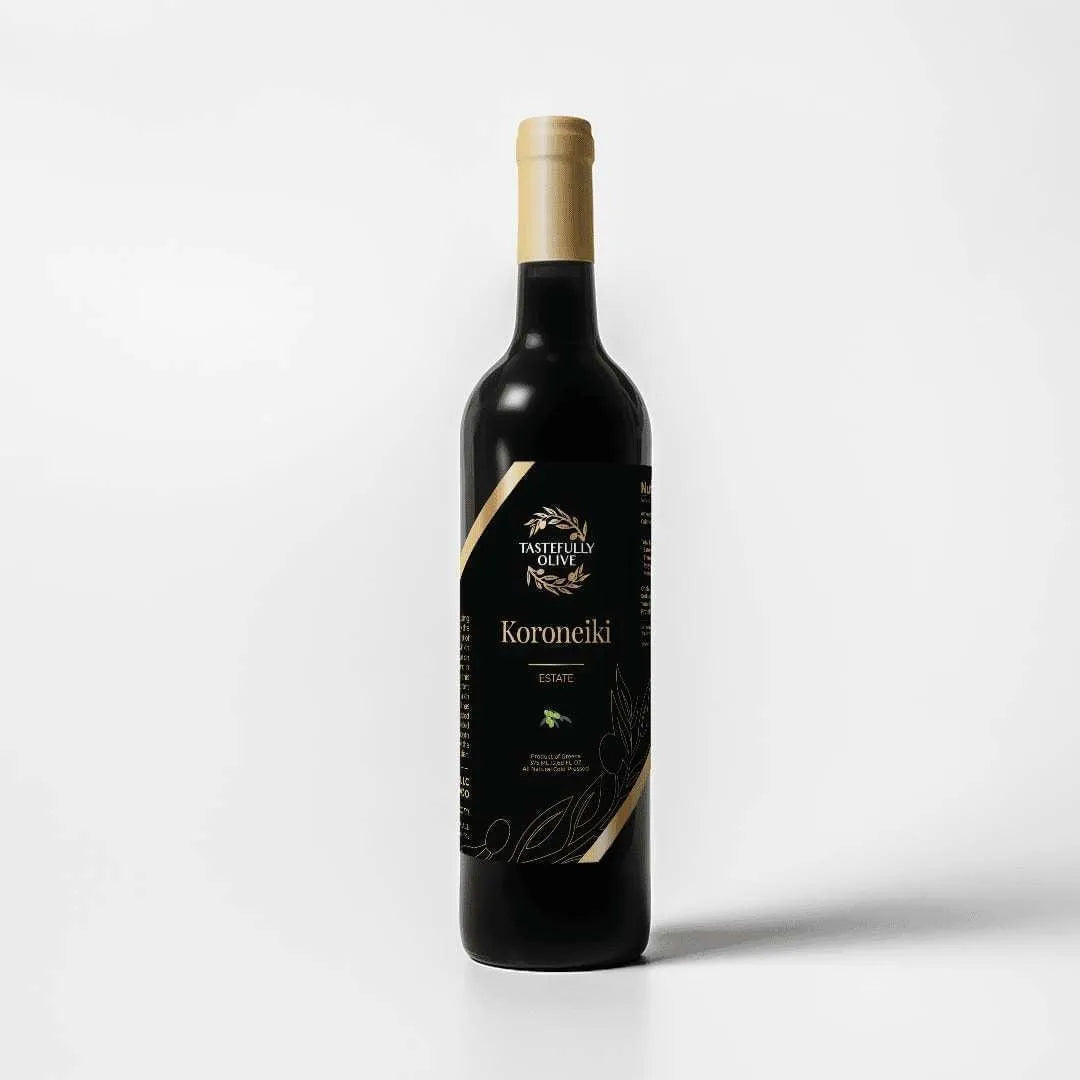 Tastefully Olive Koroneiki extra virgin olive oil bottle with a black label and gold cap on a white background.